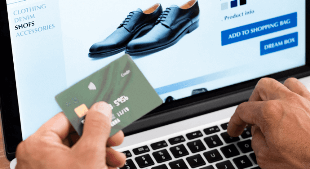 Man buying shoes online using credit card