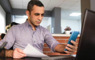 Man squinting to read phone