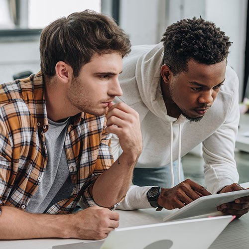 Two men concentrating on work