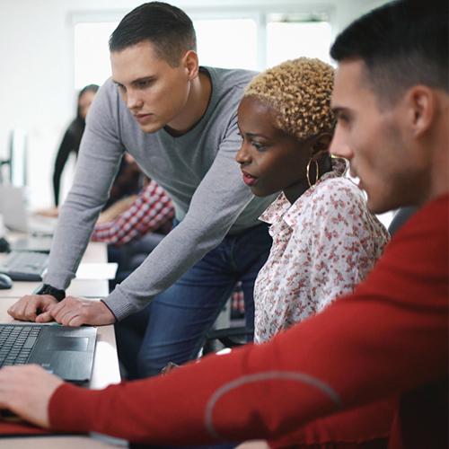 Two men and one woman developer discussing code