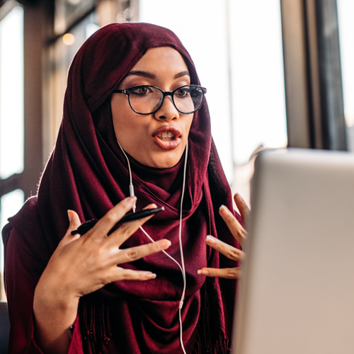 woman wearing hijab talking on a video call