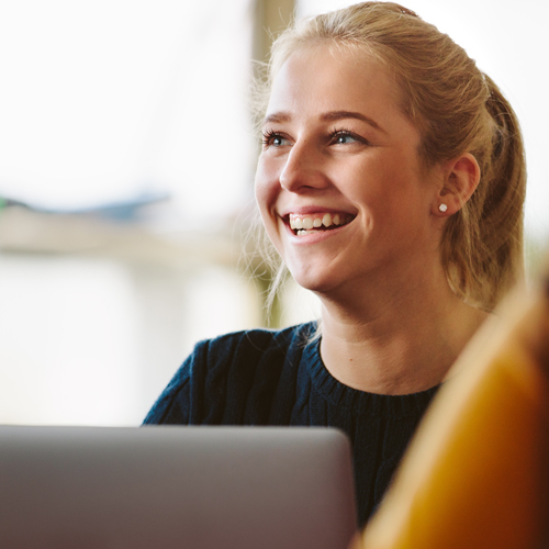 Young female worker smiling at her colleagues