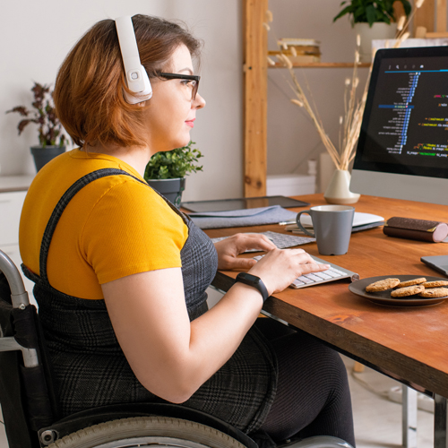 Woman in a wheelchair coding