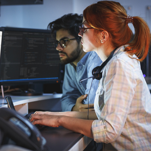 Red haired woman and man working together