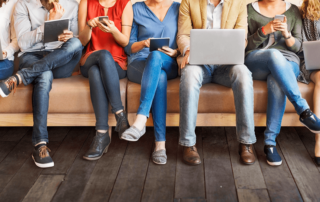 Group on sofa, using difference devices