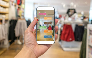 Hand holding mobile app in retail store