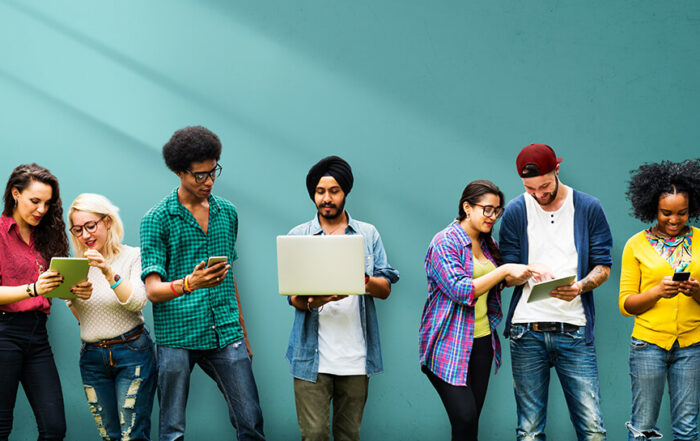 Multi-ethnic group using mobile devices