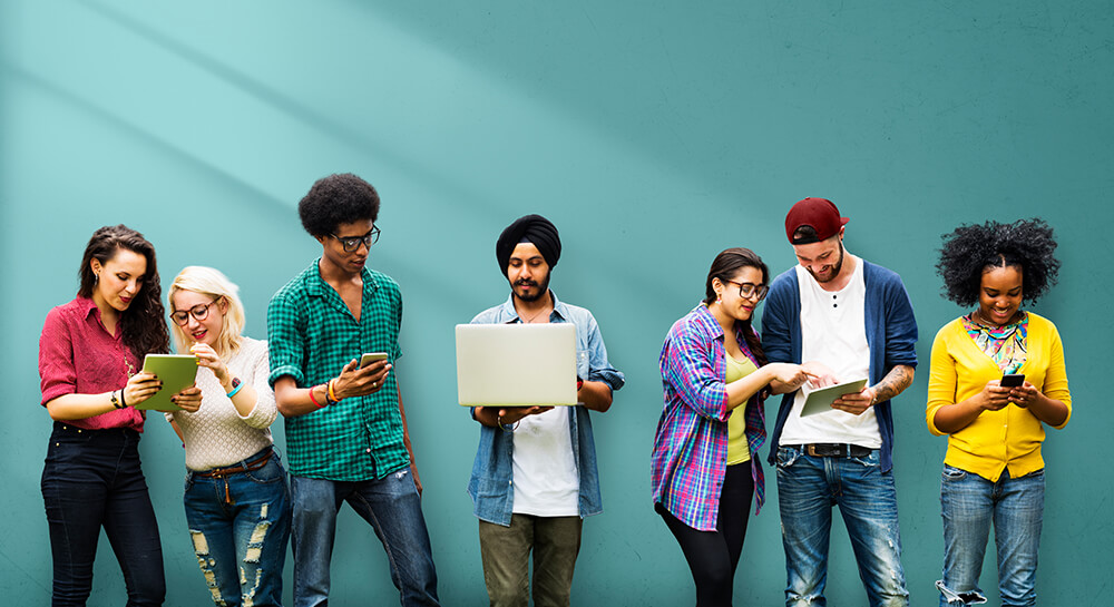 Multi-ethnic group using mobile devices