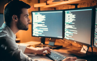 Man looking at computer code