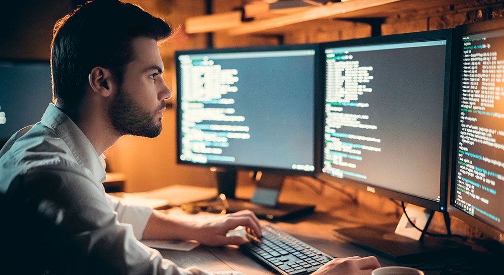 Man looking at computer code