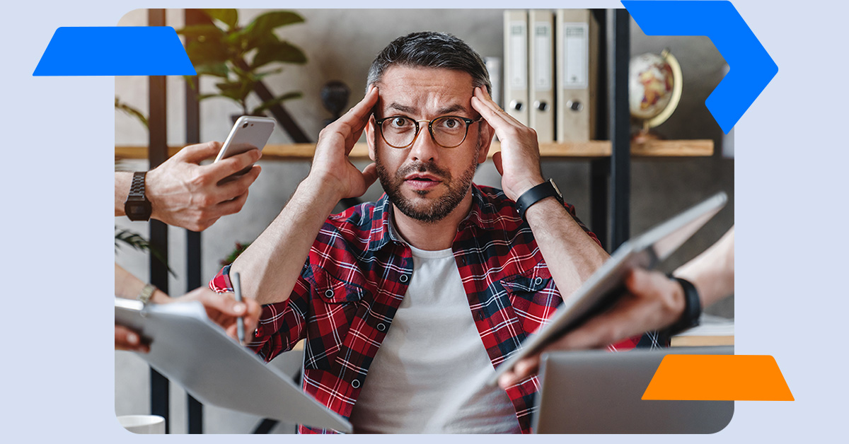 Man overwhelmed with electronic devices surrounding him