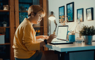 Woman testing a website on a tablet and a laptop