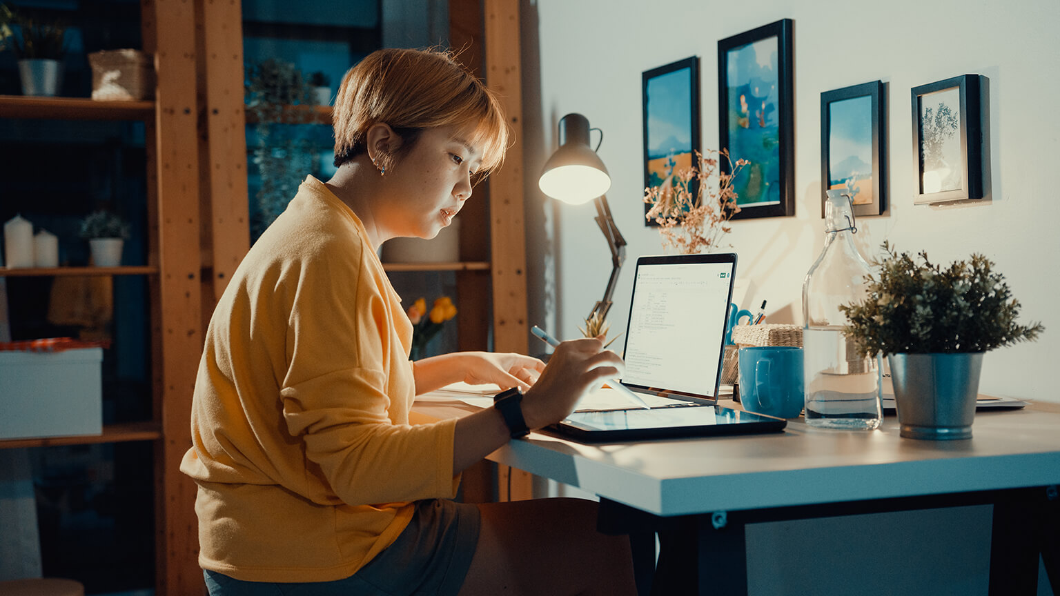 Woman testing a website on a tablet and a laptop