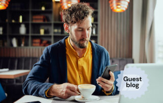 man with multiple devices testing software on a mobile phone