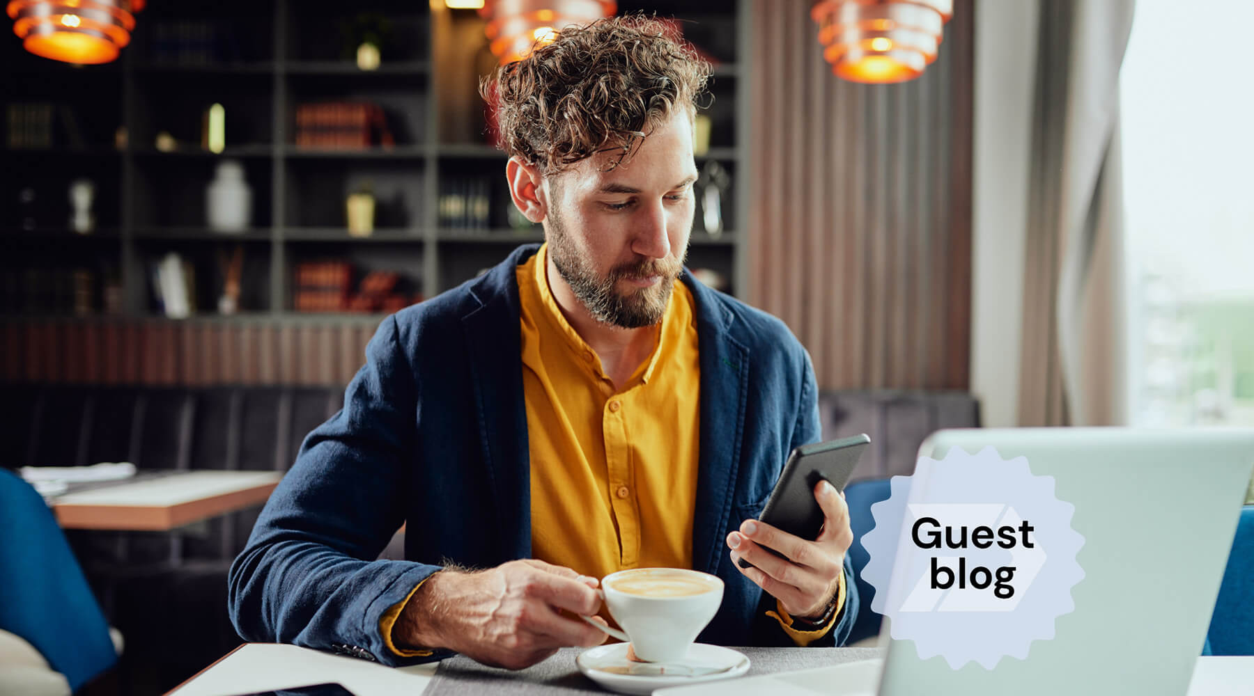 man with multiple devices testing software on a mobile phone