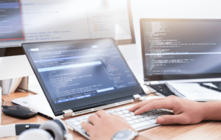 mans hands at desk computer developing